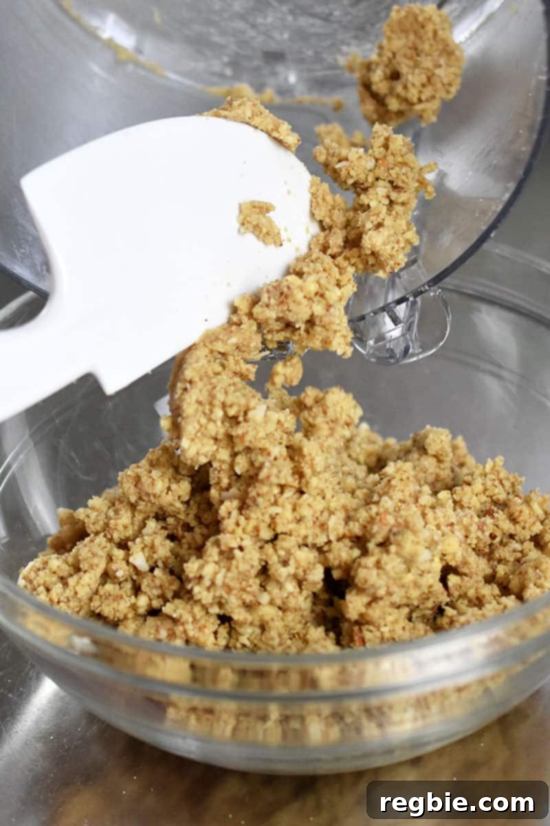 Guilt Free Apple Crisp 12 Transferring the paleo and gluten-free apple crisp topping into a bowl.