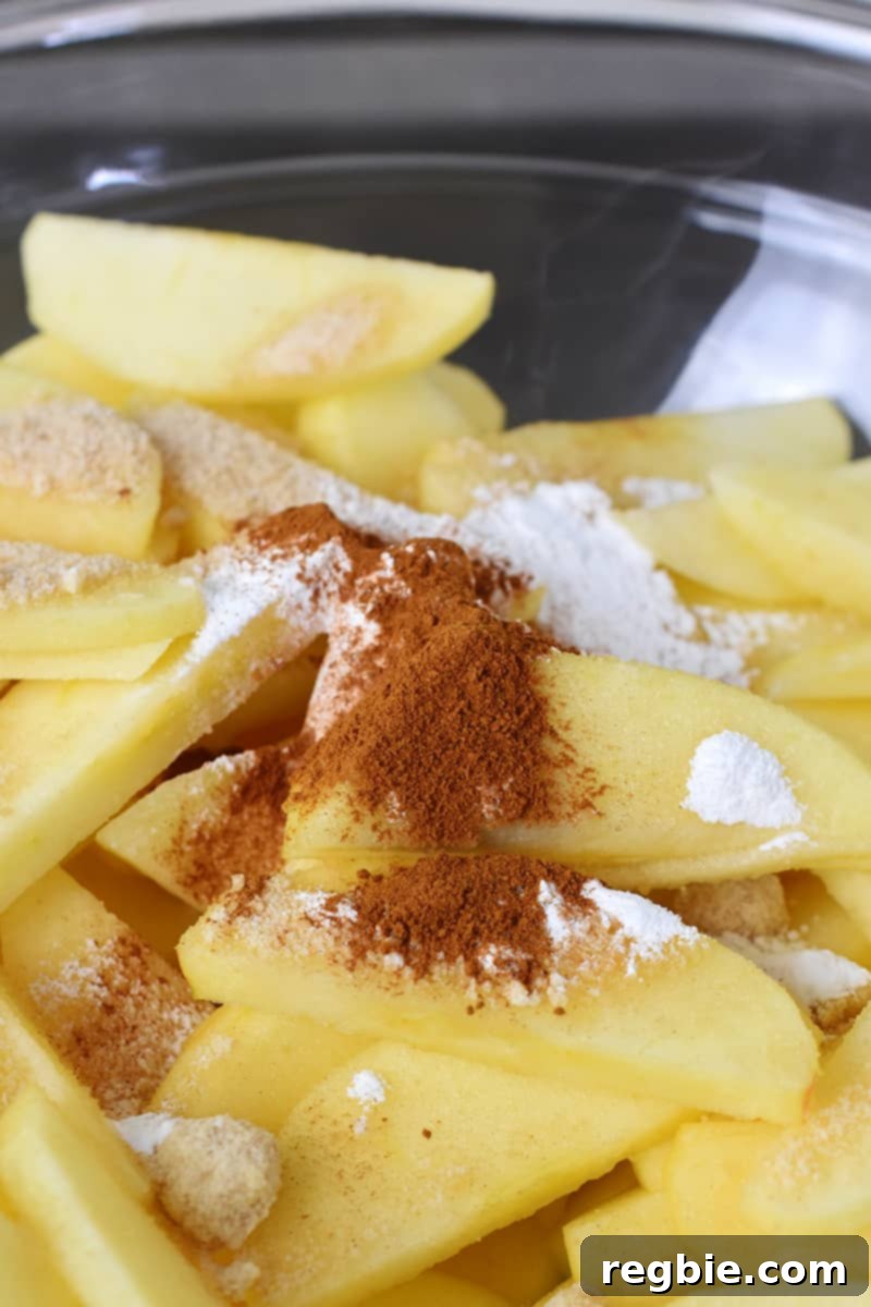 Guilt Free Apple Crisp 14 A closeup of sliced apples with seasoning for paleo apple crisp.