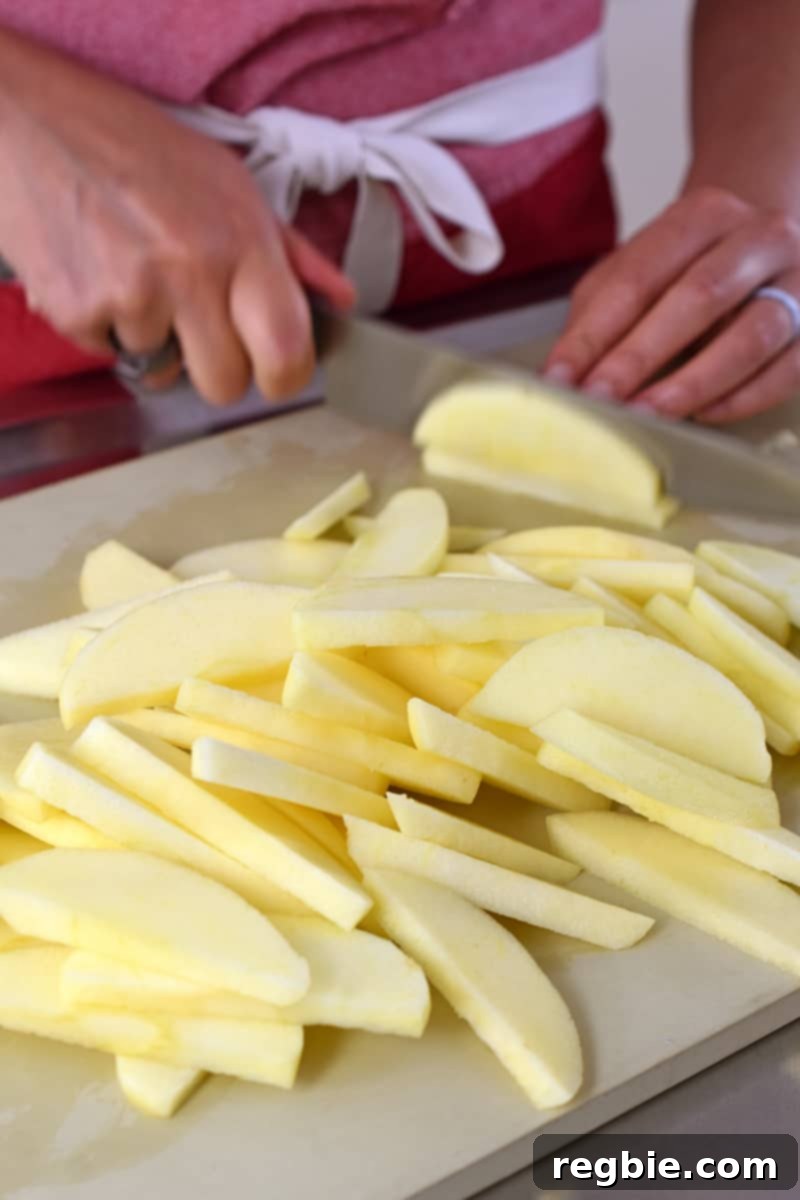 Guilt Free Apple Crisp 5 Someone slicing apples to make paleo apple crisp.