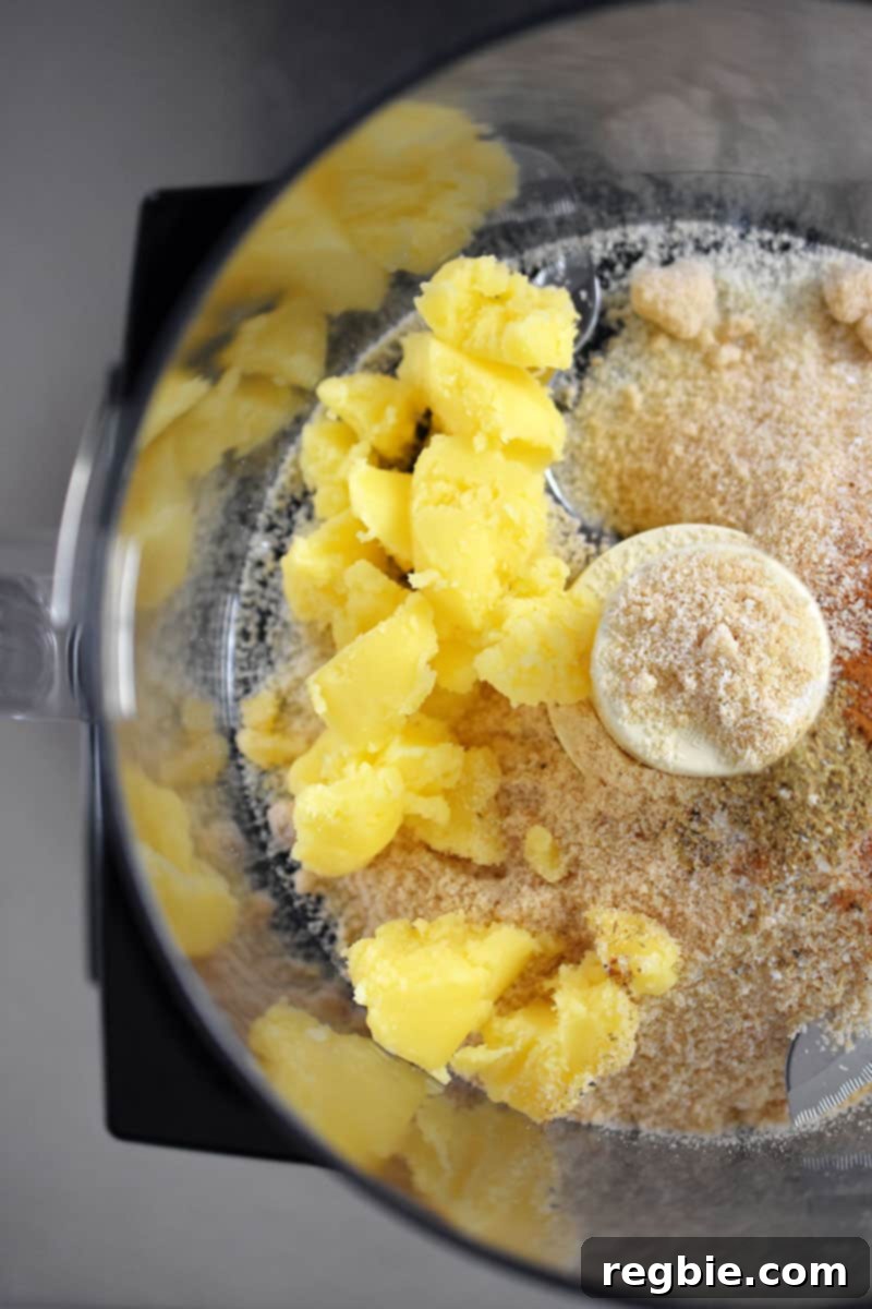 Guilt Free Apple Crisp 8 An overhead shot of an open food processor with the crisp dry ingredients and chilled ghee cubes.