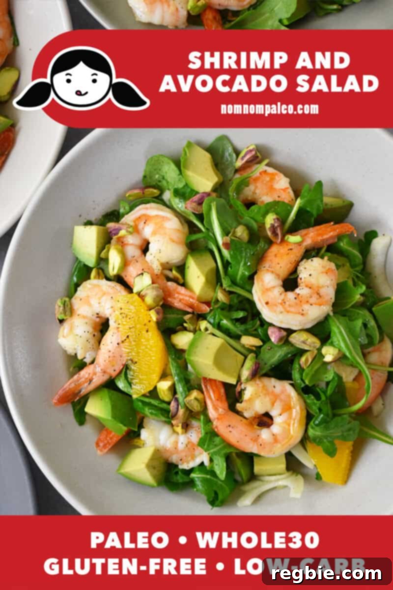 An overhead shot of a bowl filled with shrimp and avocado salad. There is a red banner at the bottom that reads paleo, whole30, gluten-free and low carb