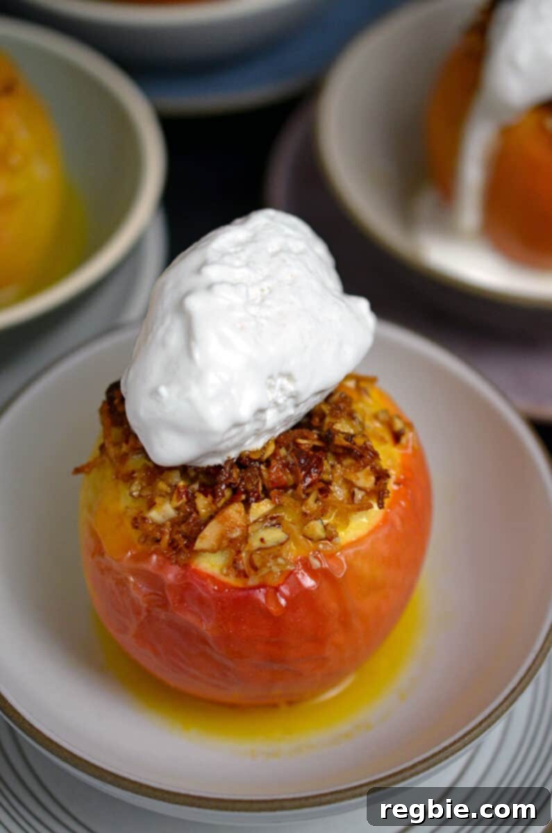 Wholesome Spiced Baked Apples 3 A closeup of a baked apple topped with whipped coconut cream.