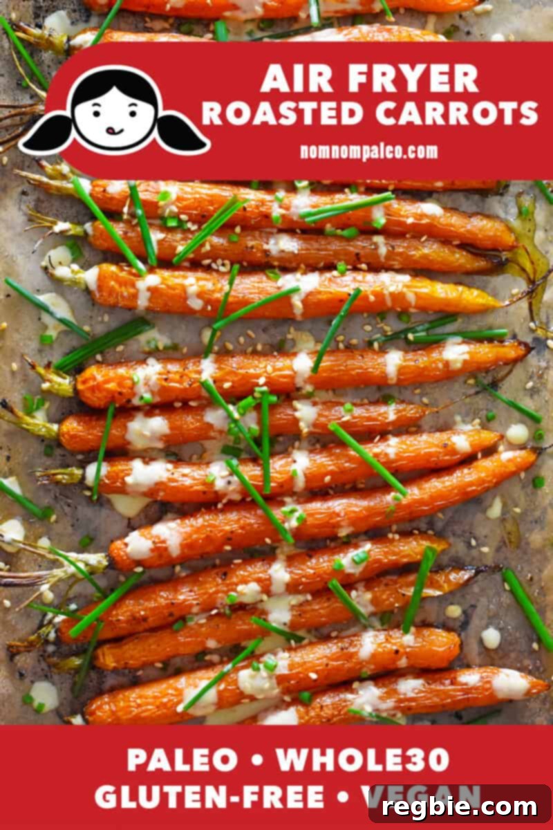 Golden Roasted Air Fryer Carrots 2 An overhead shot of air fryer carrots with sesame ginger dressing and fresh chives.