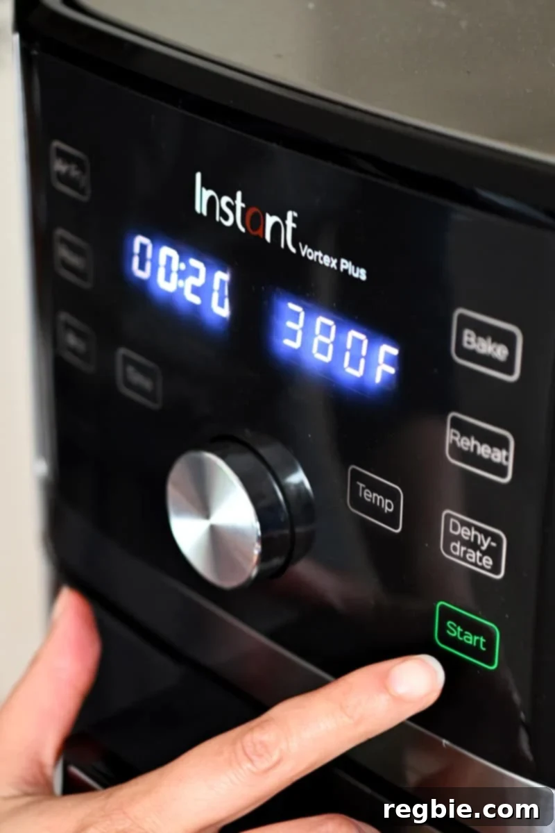 Golden Roasted Air Fryer Carrots 6 A person is programming an Instant Pot air fryer to air fry at 380F for 20 minutes.