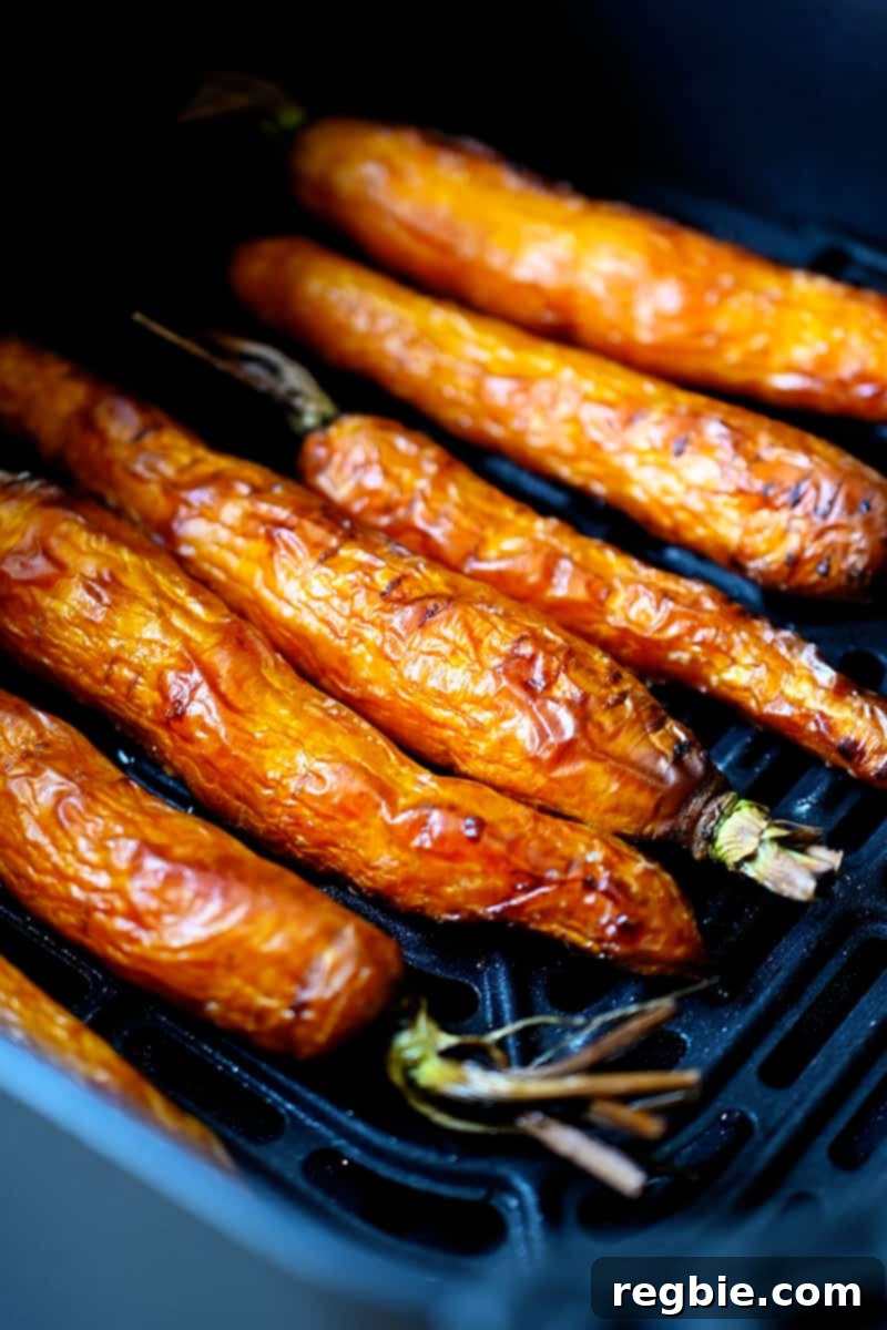 Golden Roasted Air Fryer Carrots 8 An overhead shot of golden brown carrots in an open air fryer.