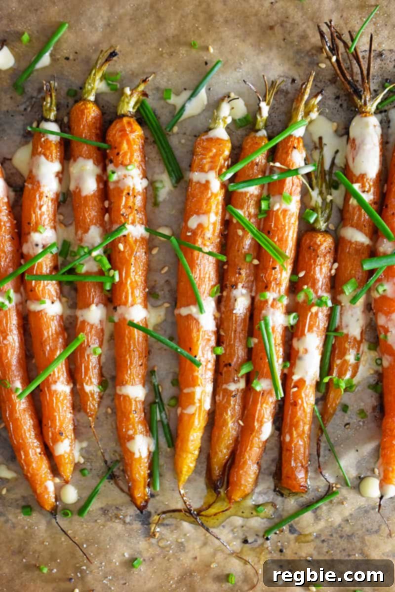Golden Roasted Air Fryer Carrots 10 An overhead shot of air fryer roasted carrots topped with ginger sesame dressing and fresh chives.