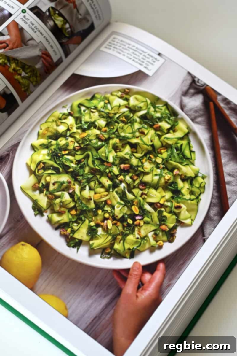 Nom Nom Paleo Lets Go Cookbook Launch Crew 5 A beautifully presented page from Nom Nom Paleo: Let's Go! featuring a vivid photograph of a Zucchini Carpaccio Salad, alongside its recipe.