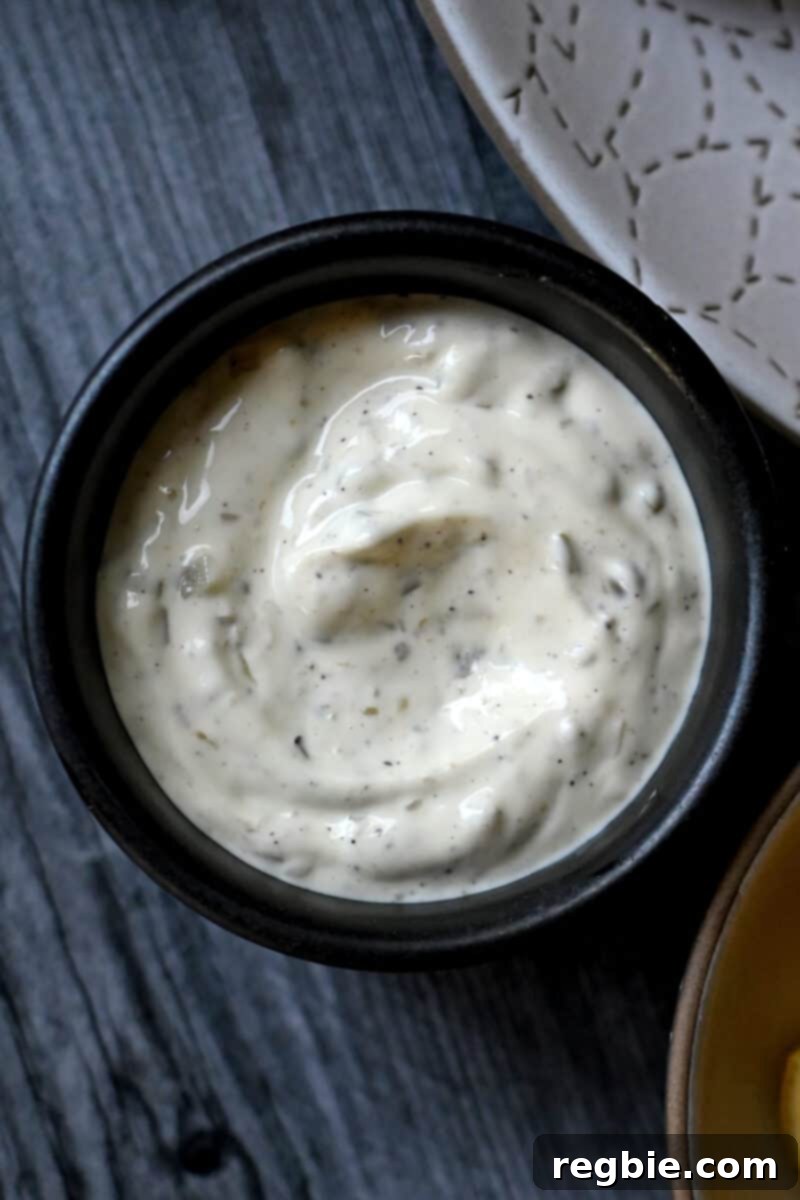 Whip Up Perfect Homemade Tartar Sauce 2 An overhead shot of a black bowl filled with homemade paleo tartar sauce