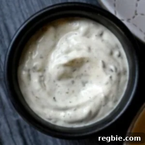 An overhead shot of a black bowl filled with homemade paleo tartar sauce