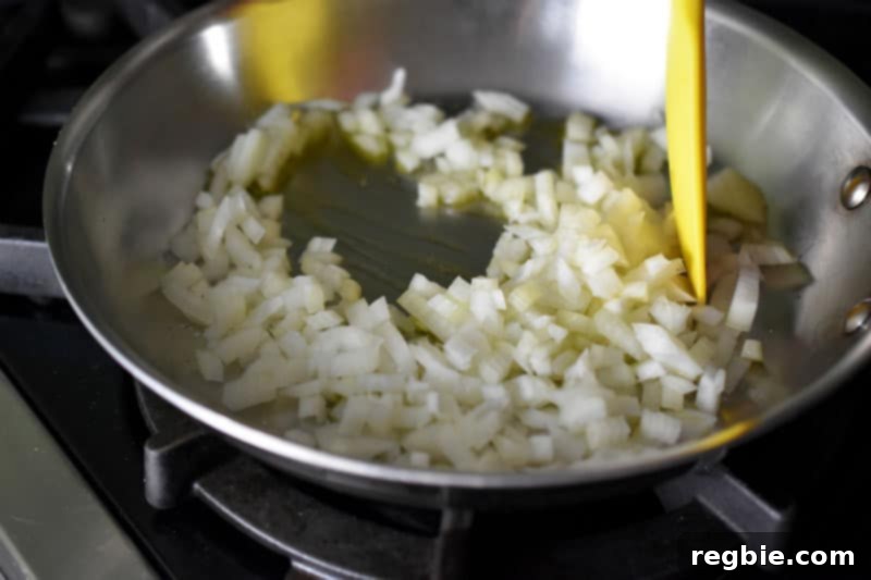 Onions sautéing in a pan.