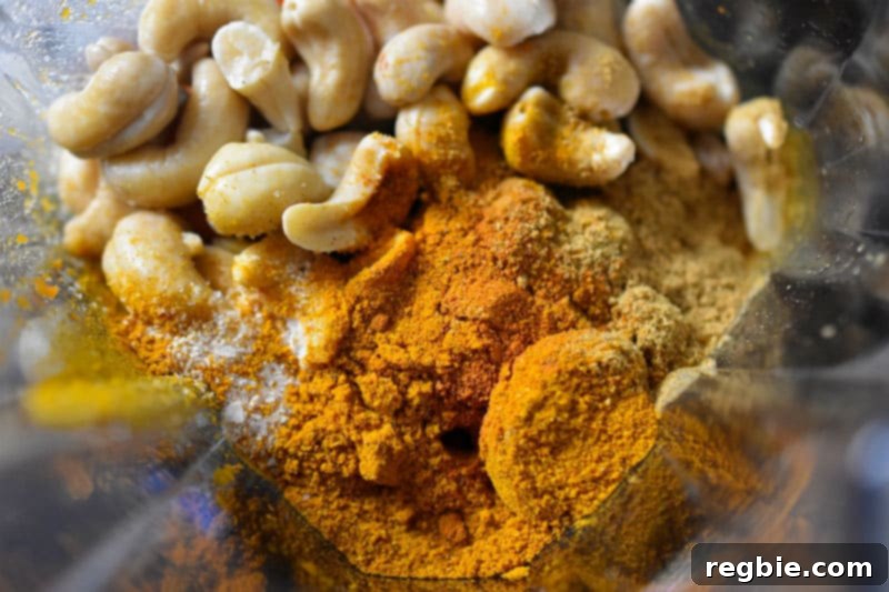 An overhead shot into the blender that has the ingredients for the paleo sweet potato and cashew dip.