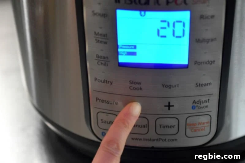 An Instant Pot display illuminated, showing the programmed cooking time of 20 minutes under high pressure.