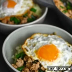 Two bowls with Thai Basil Chicken topped with crispy fried egg