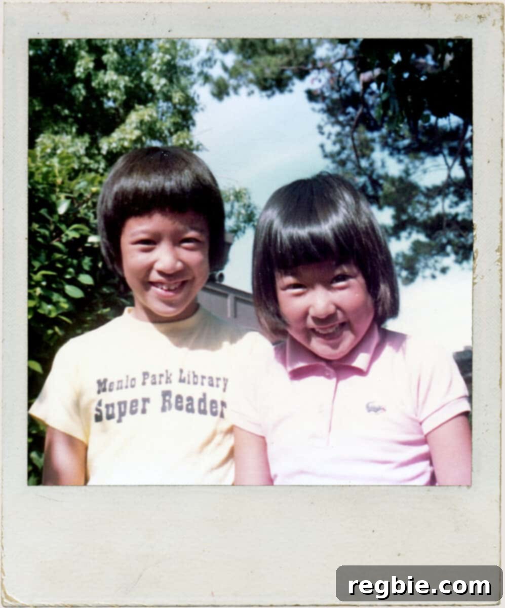 A charming vintage Polaroid photograph captures Fiona and Michelle as children. Fiona, proudly wearing a T-shirt that reads "Menlo Park Library Super Reader," stands beside a smiling Michelle, evoking a sense of nostalgia and shared history.