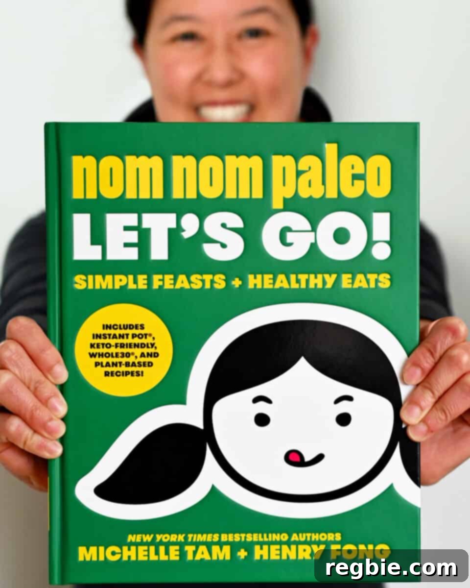 Nom Nom Paleo: Your Flavor Journey Begins 2 Two hands holding out a copy of the Nom Nom Paleo: Let's Go! cookbook by Michelle Tam and Henry Fong