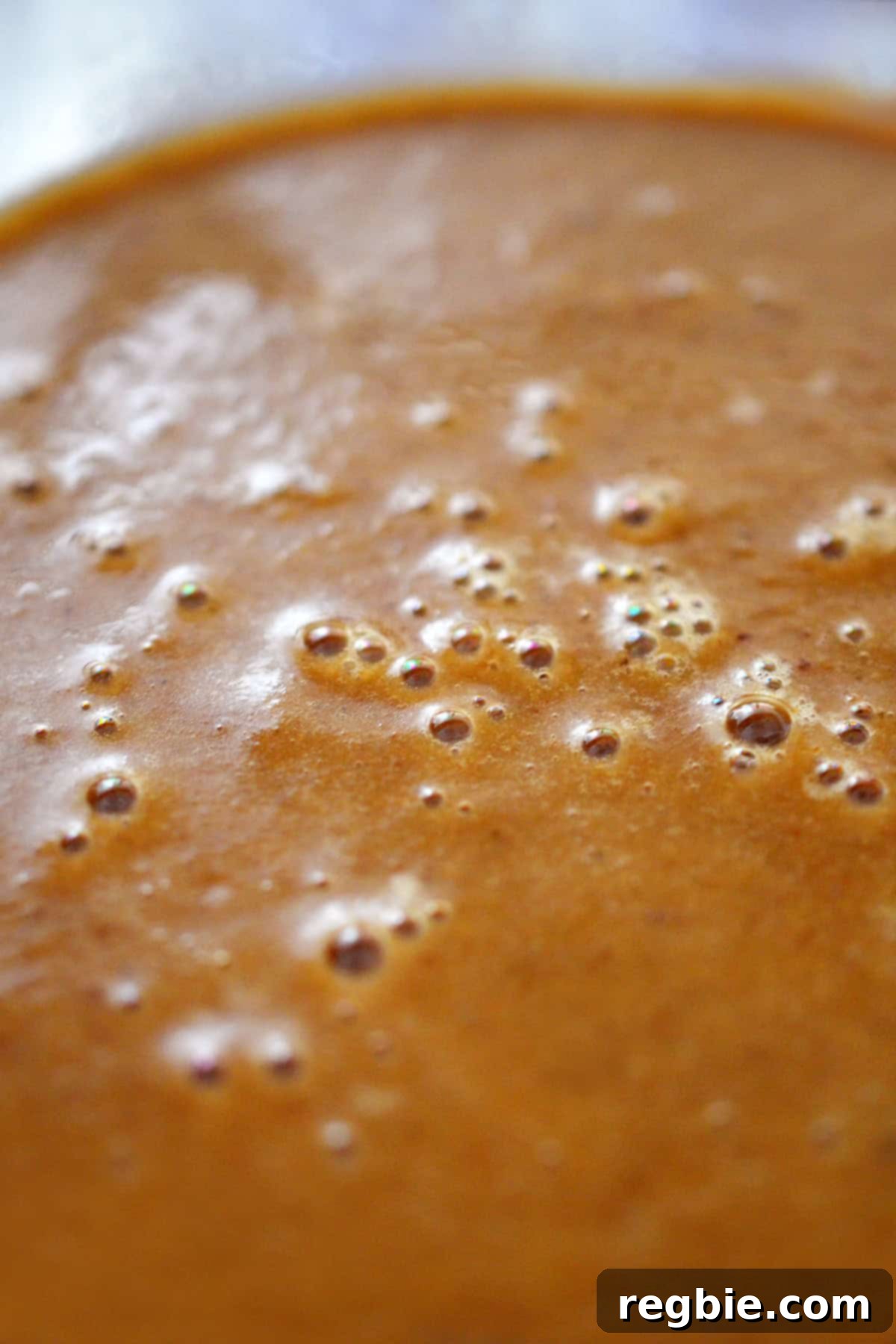 A closeup of a bowl of smooth gluten free gravy.