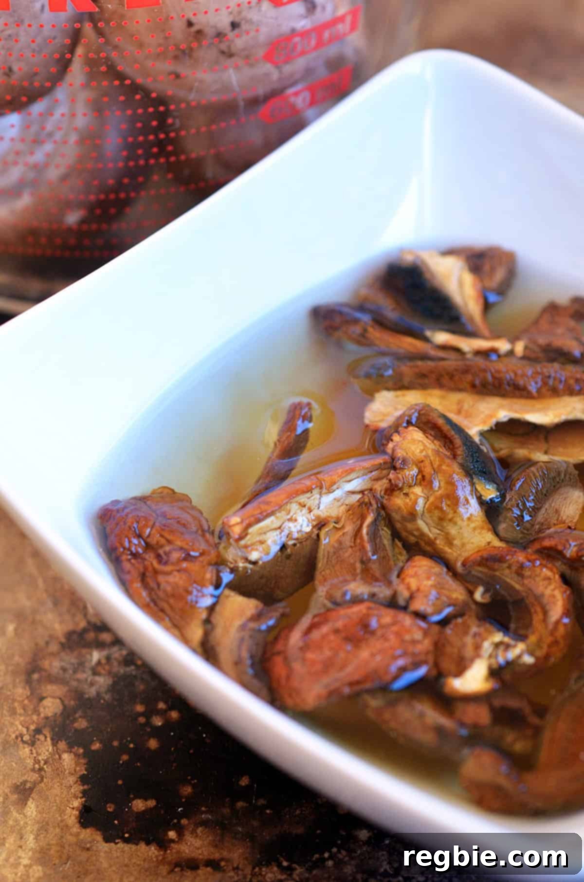 Dried porcini mushrooms soaking in water in a white bowl to make a gluten free gravy.