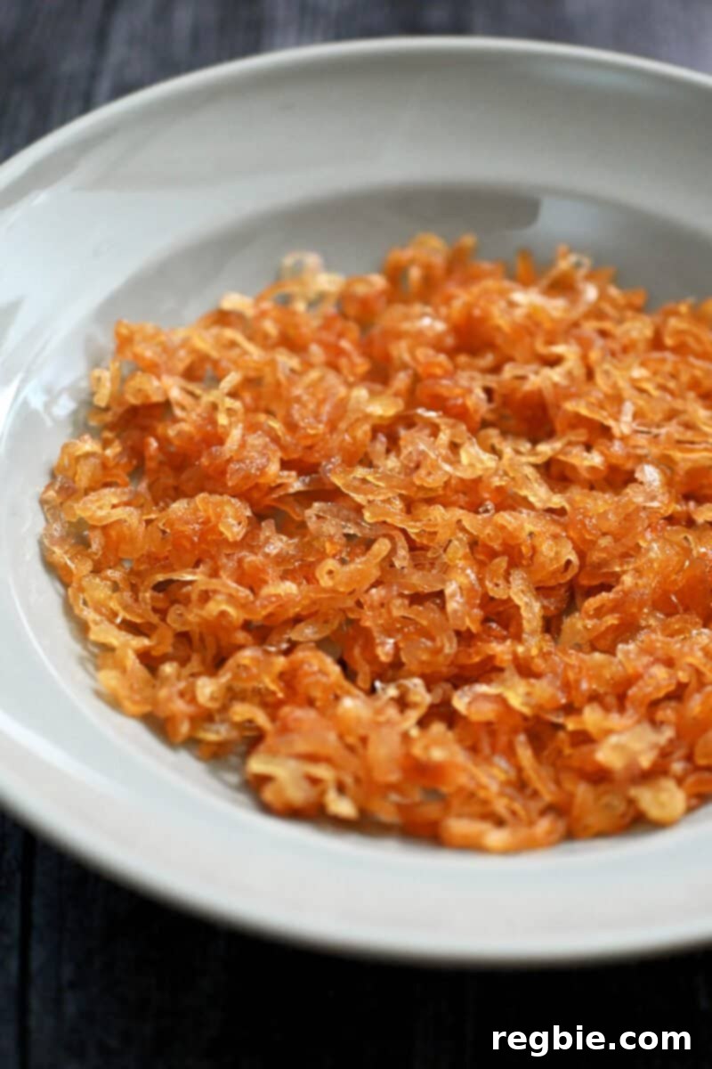 A shallow blue bowl is filled with golden crispy shallots, perfectly fried and ready to enjoy.