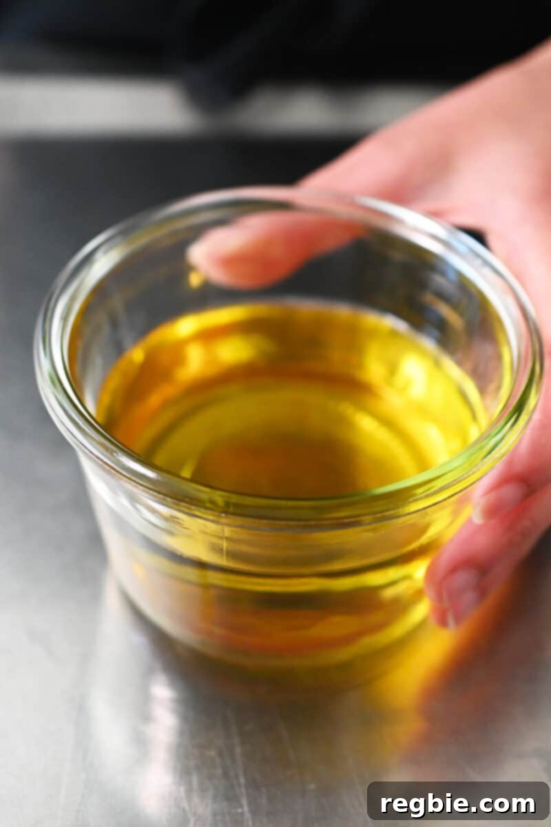 An open glass jar sits, gleaming with golden shallot oil, ready for use.