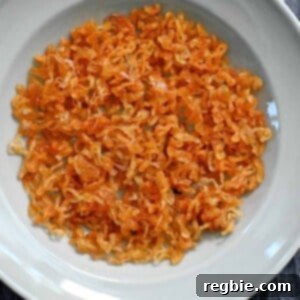 An overhead shot of a light blue plate filled with golden brown crispy shallots, garnished for serving.