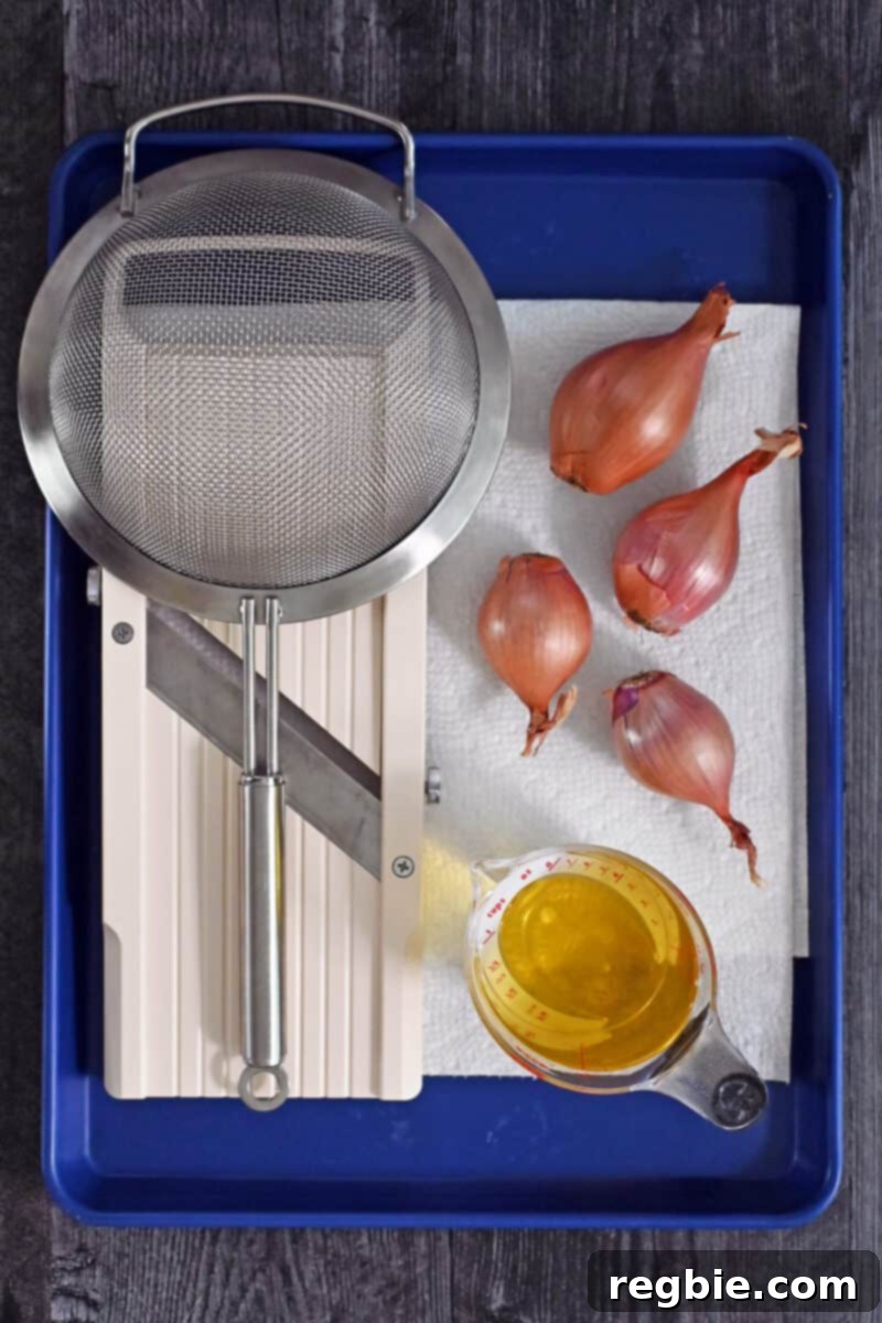 An overhead shot showcasing all the necessary equipment and raw ingredients for making crispy shallots in the microwave, neatly arranged.