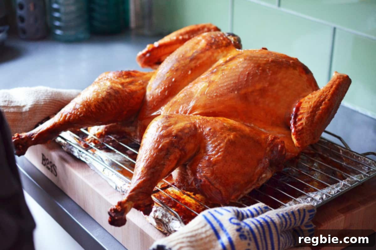 A beautifully roasted golden brown spatchcock turkey resting on a wooden cutting board after cooking.
