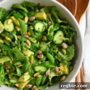 An overhead shot of a big white bowl filled with a vegan and Whole30 chopped salad with sesame ginger dressing.
