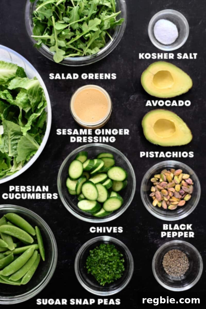 Whole30 Vegan Asian Chopped Salad 5 An overhead shot displaying all the raw, fresh ingredients meticulously arranged for the chopped salad with sesame ginger dressing, including various greens, cucumbers, avocado, nuts, and sugar snap peas.