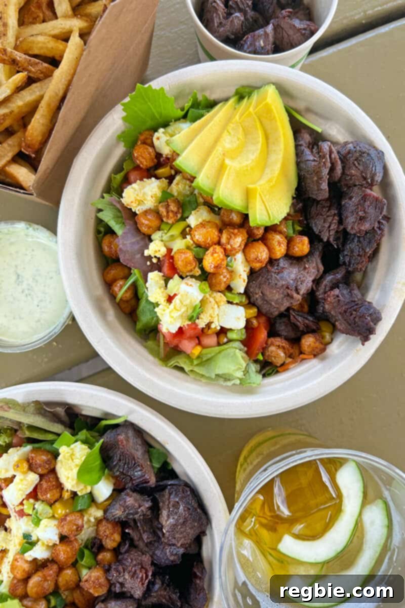An inviting overhead shot displaying two vibrant and freshly prepared gluten-free salads from Fresh Bite in Kauai, bursting with colorful ingredients.