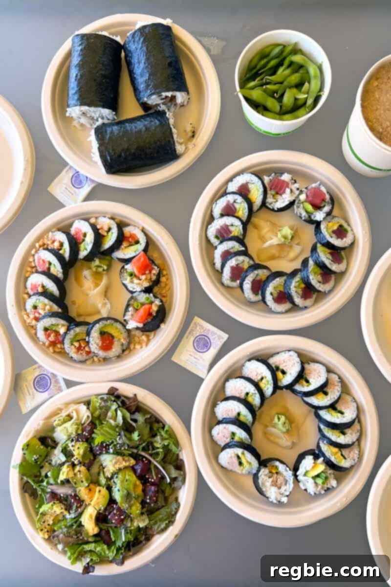 An appetizing overhead shot showcasing a delightful spread of takeout sushi, savory poke, and classic spam musubi from Sushi Girl Kauai, all guaranteed gluten-free.