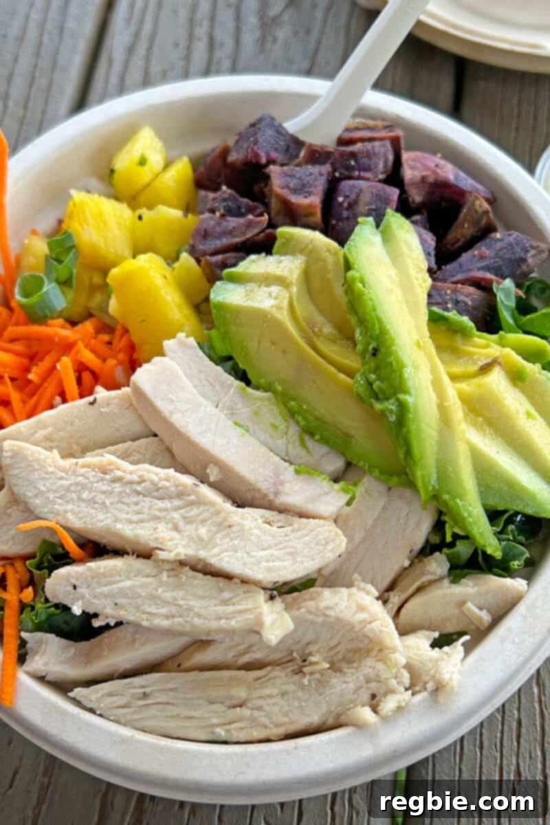 A beautifully composed salad from Nourish Hanalei in Kauai, showcasing fresh, vibrant greens and colorful toppings, set against a natural backdrop.