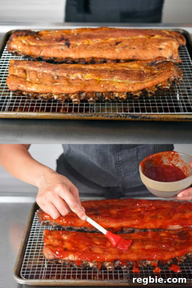 Brushing the barbecue sauce on the oven baked baby back ribs.