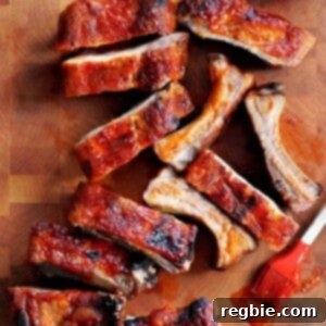 An overhead shot of oven baked baby back ribs with a Whole30, paleo, and gluten free BBQ sauce brushed in top.