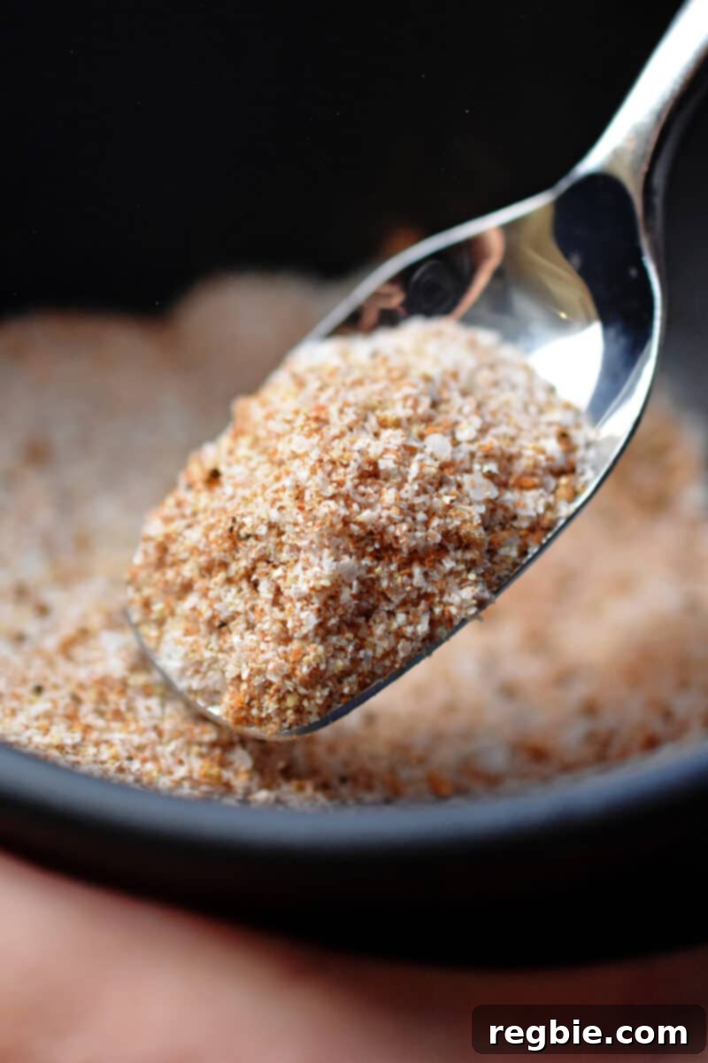 A spoon is mixing together the dry rub mix for bangin' baby back ribs.
