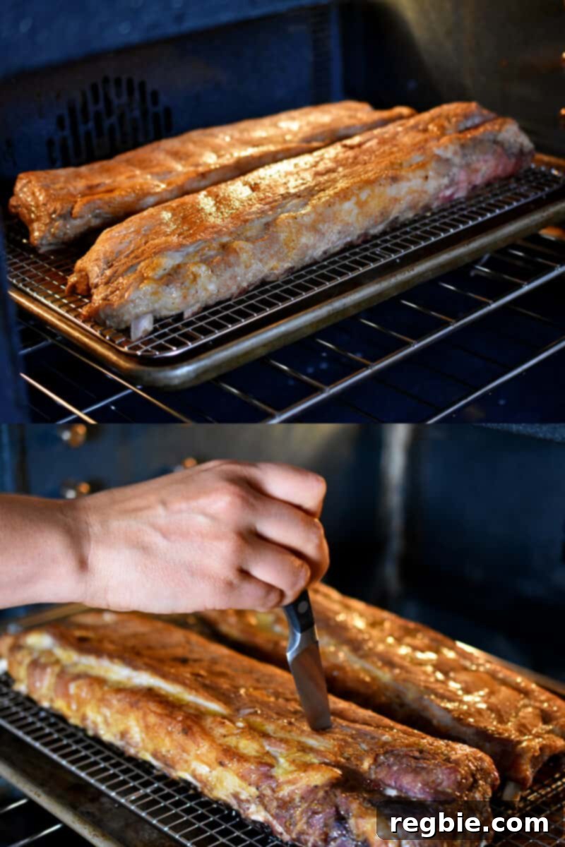 Two racks of baby back ribs are baking in the oven without foil.