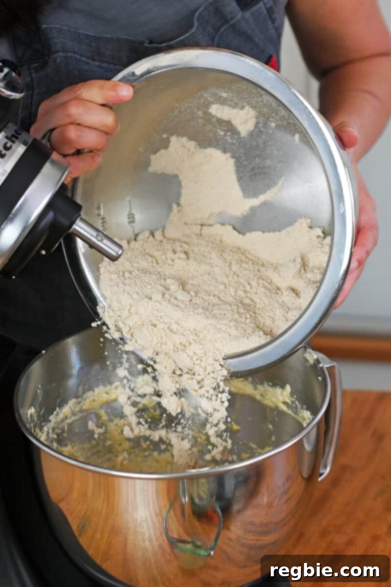 Peach Cloud Cake Paleo Gluten Free 13 Pouring half of the paleo and gluten free flour mixture into the mixing bowl.