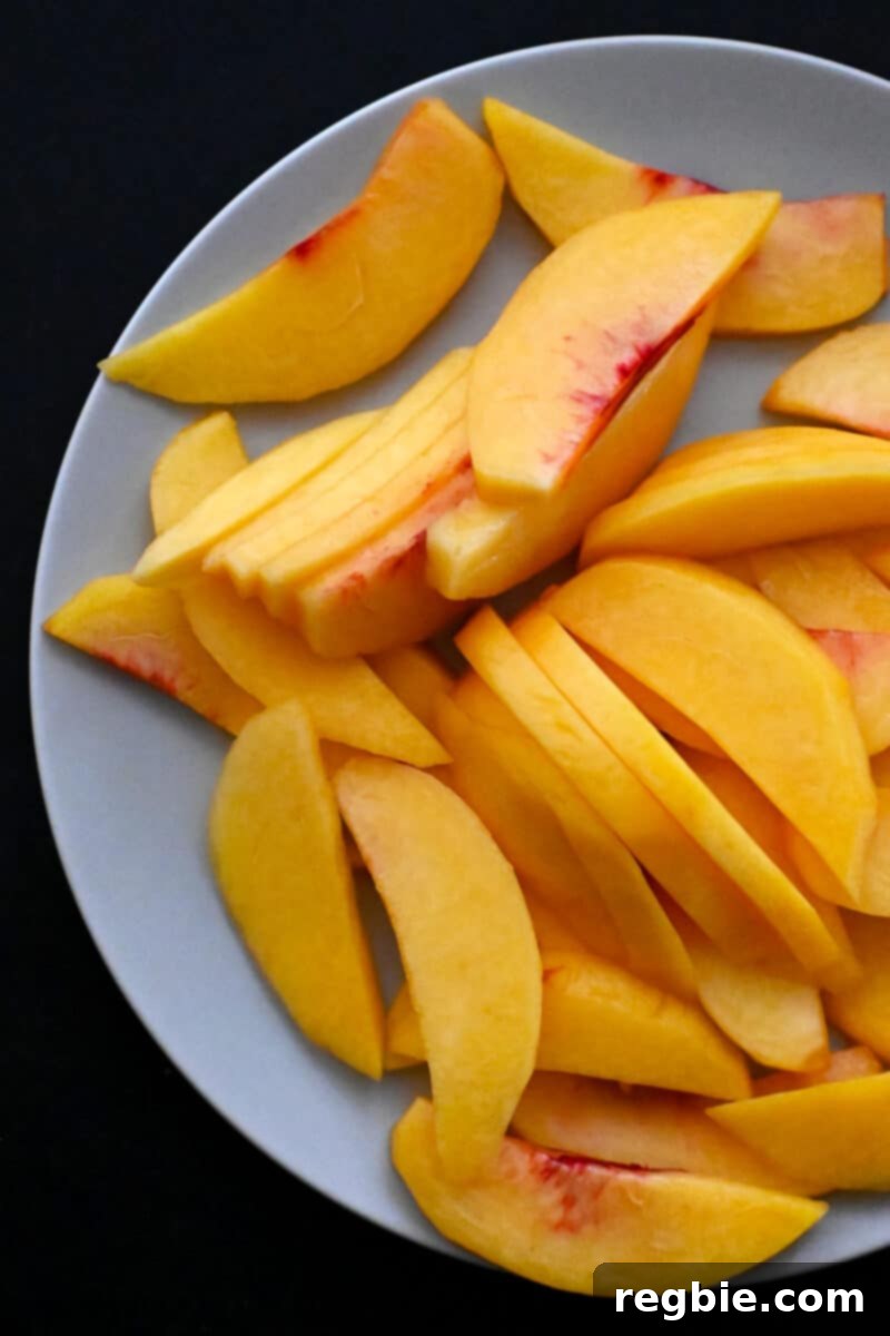 Peach Cloud Cake Paleo Gluten Free 4 A plate is filled with thin slices of peeled peaches.