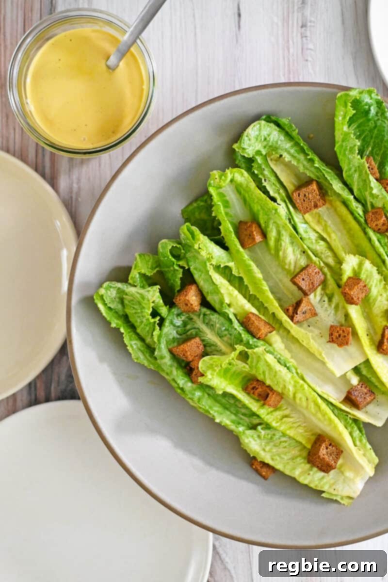 Creamy Dairy Free Caesar Dressing Whole30 Keto 9 A stunning paleo dairy-free Caesar salad, complete with golden gluten-free croutons, artfully arranged on a serving platter.