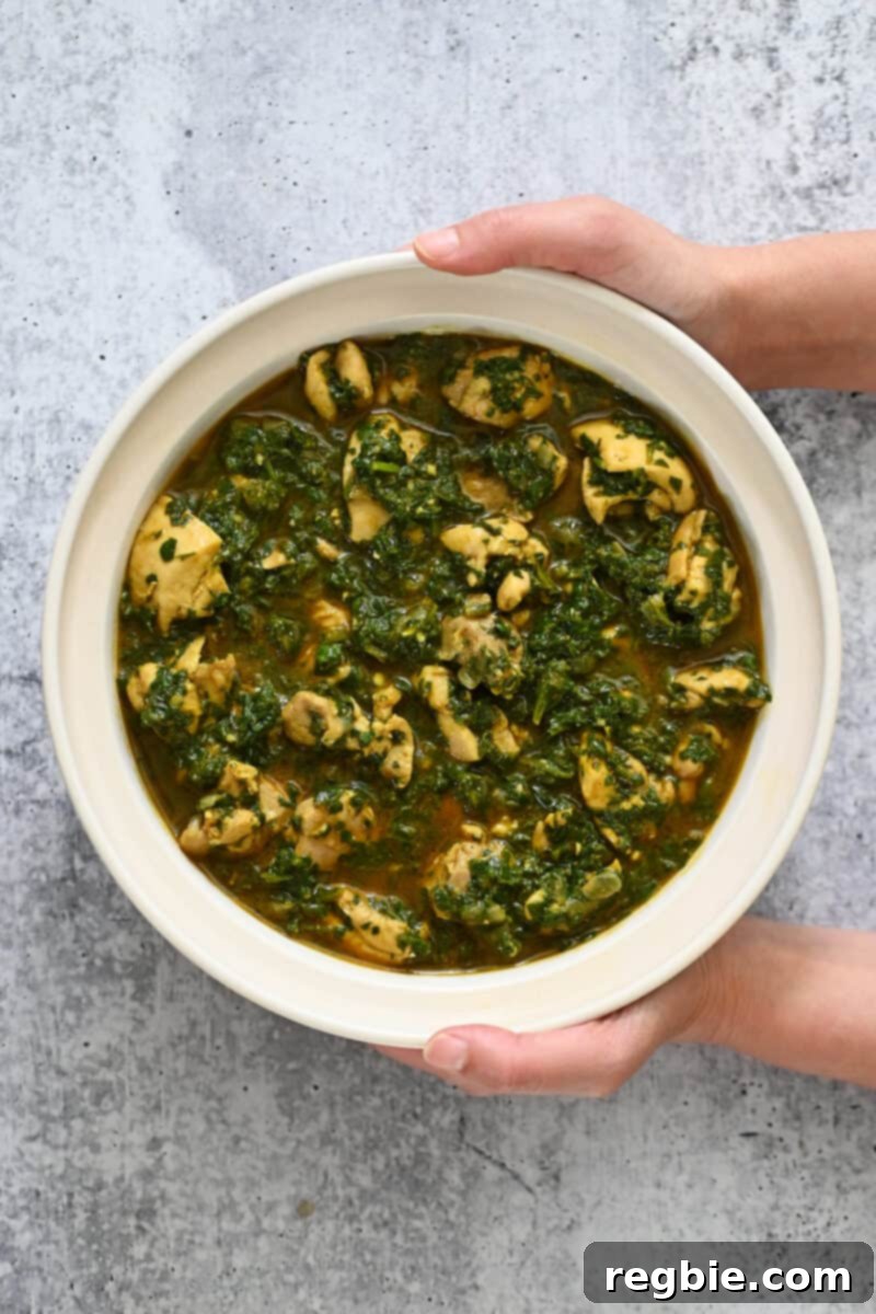 Healthy Instant Pot Chicken Saag Whole30 Keto 2 An overhead shot of a bowl containing chicken saag, an Indian curry with spinach and chicken.