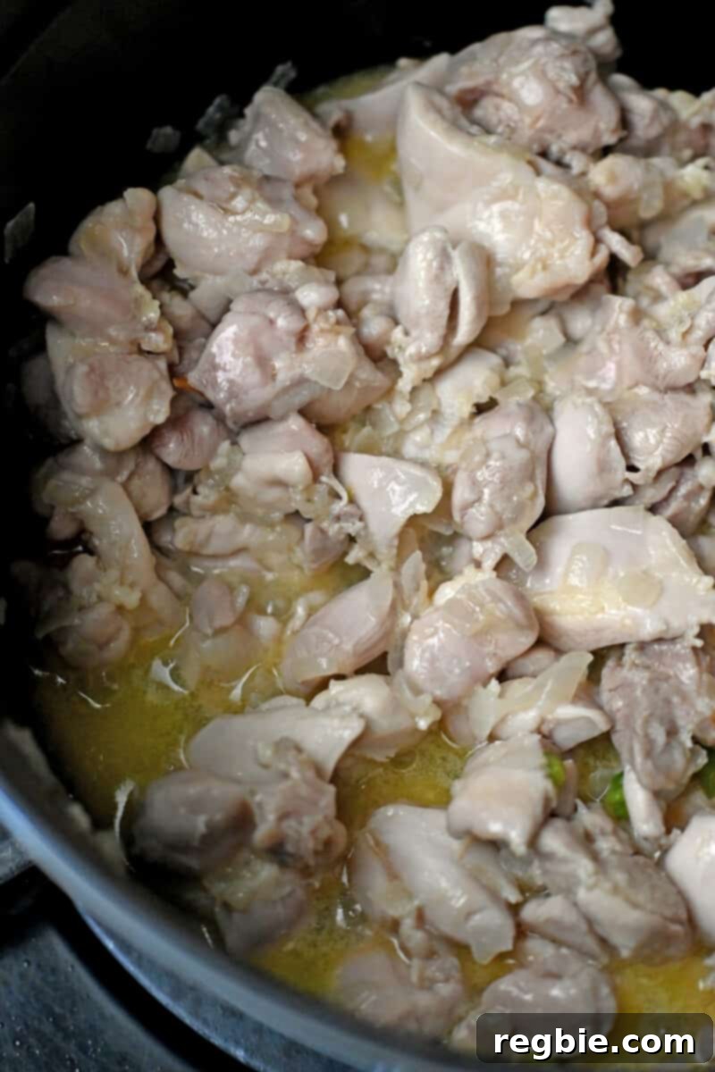Healthy Instant Pot Chicken Saag Whole30 Keto 11 An overhead shot of cooked cut-up chicken thighs that are no longer pink.