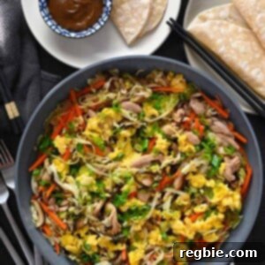 An overhead shot of a big plate of Moo Shu Chicken, with gluten free and Whole30 hoisin sauce and wrappers.