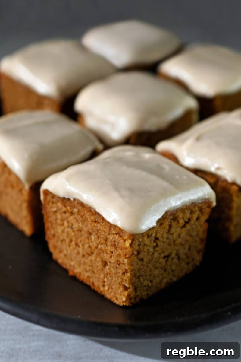 Guilt Free Paleo Pumpkin Bars 15 A close-up of a finished paleo pumpkin bar, perfectly cut into squares, showing the moist interior and decadent frosting.