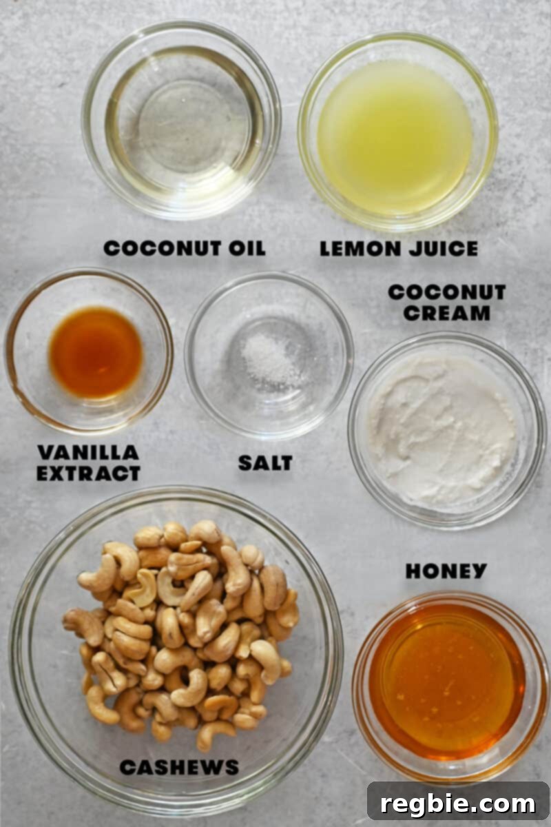 A flat lay of the raw ingredients for vegan and paleo cream cheese frosting, including cashews, coconut oil, and lemon.