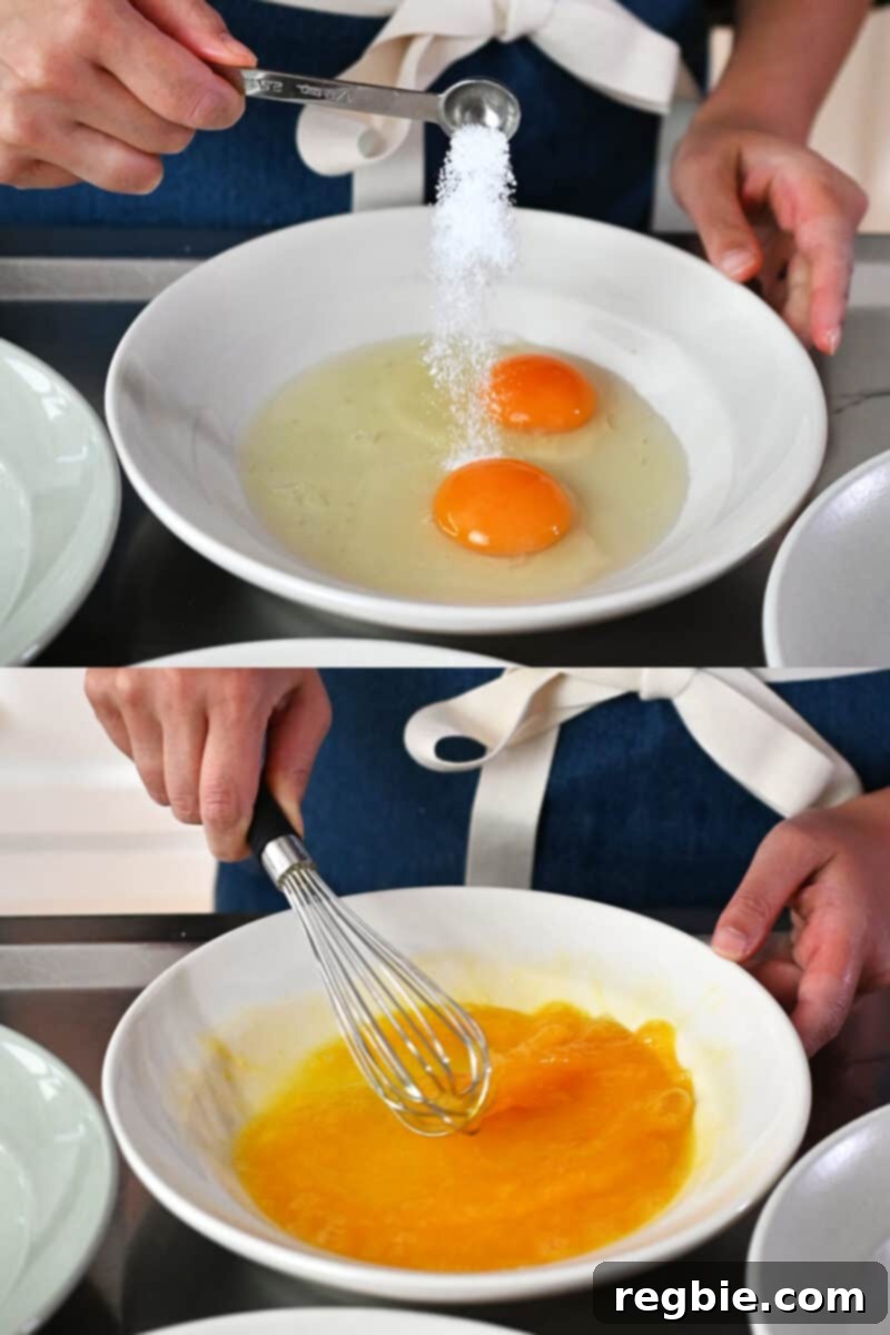 A hand whisking two large eggs and salt in a shallow dish to create an egg wash for breading.