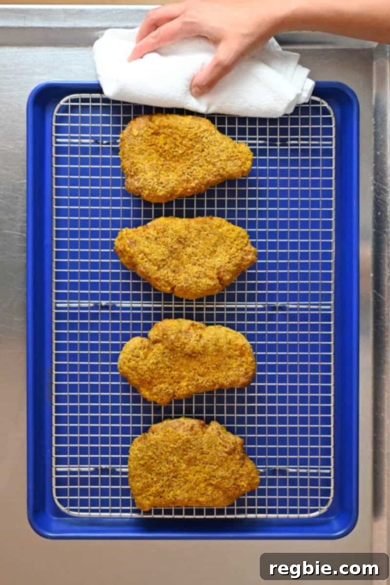 A tray of freshly baked golden brown gluten-free pork katsu, perfectly crispy and ready to be served.