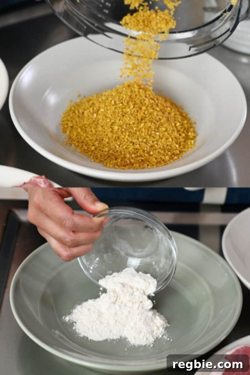 One shallow bowl containing the crushed plantain chips and another shallow dish with cassava flour, set up for a breading station.