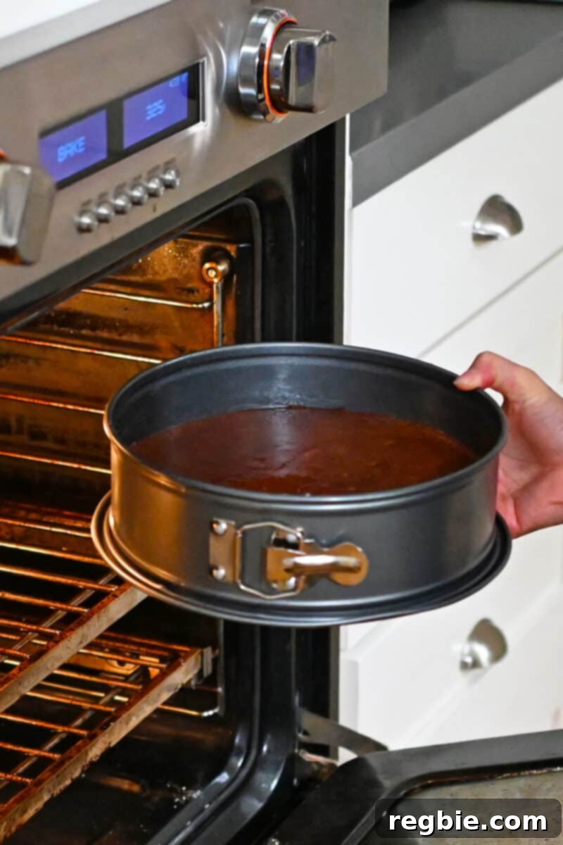 Caprese Chocolate Almond Torte 18 Putting a springform cake pan filled with Torta Caprese batter into an oven.