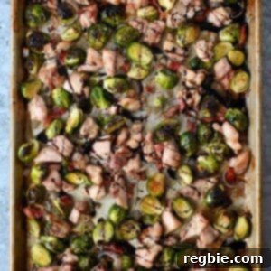 One Pan Chicken and Crispy Brussels Bake 13 An overhead shot of a sheet pan filled with perfectly roasted chicken thighs, caramelized Brussels sprouts, and crispy bacon, ready for serving.