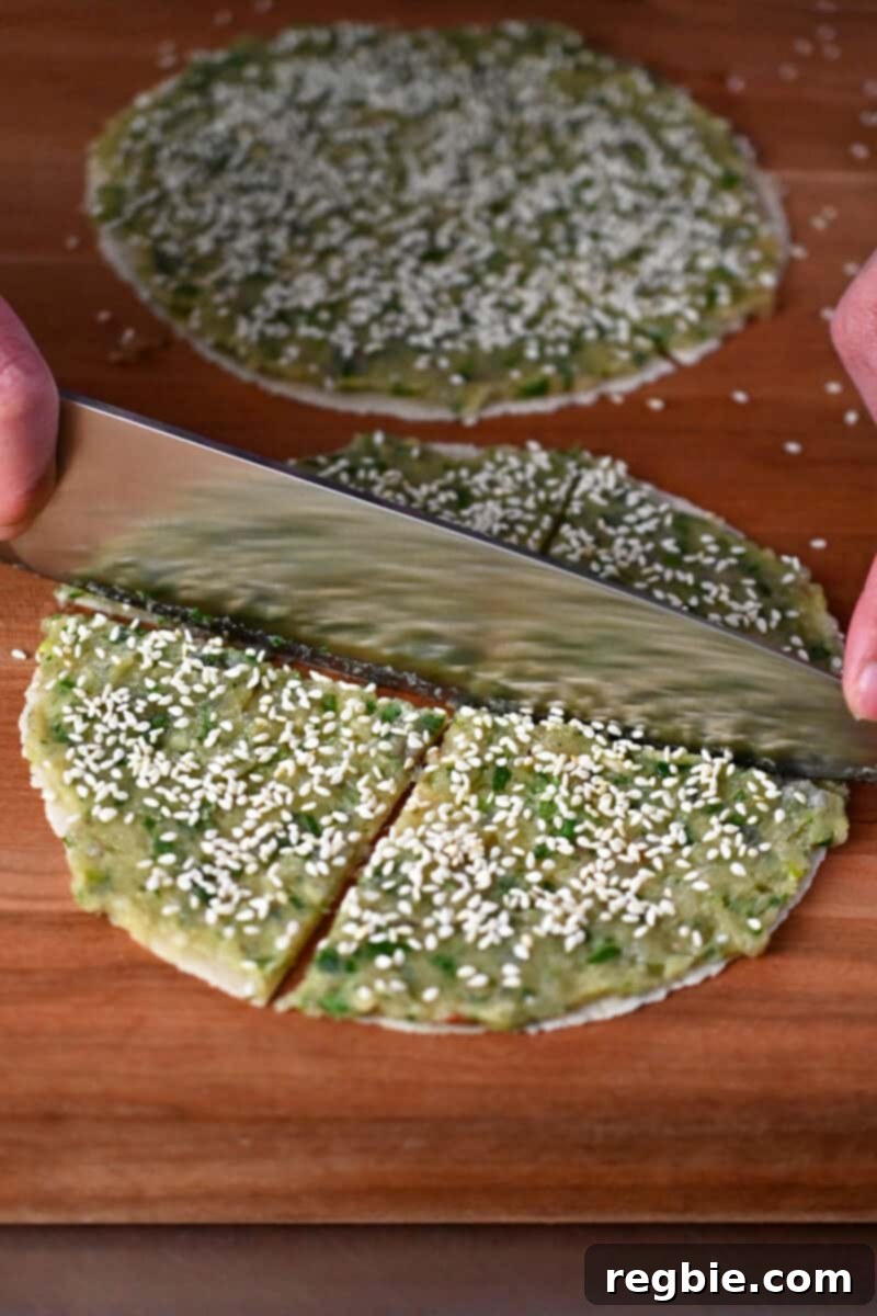 Wholesome Paleo Shrimp Toast 11 A chef's knife precisely cutting the raw shrimp toast tortillas into four uniform wedges.