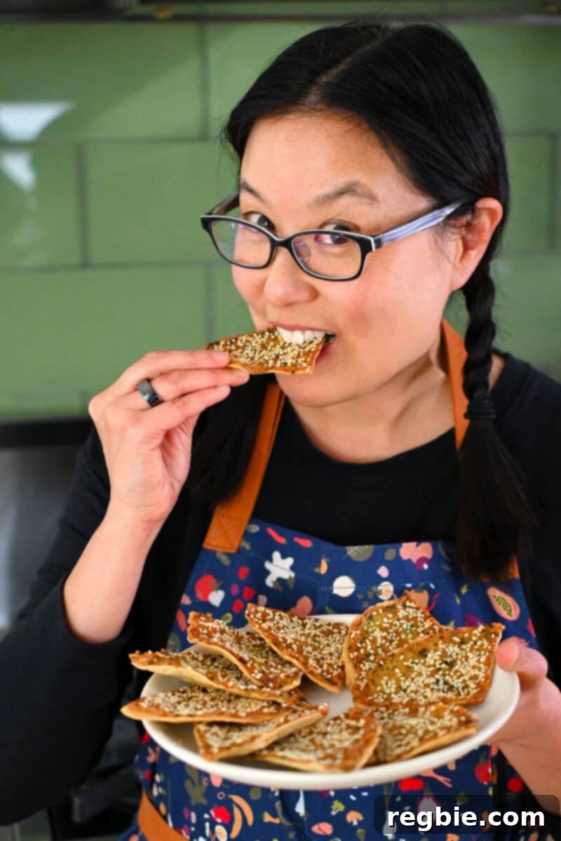 Wholesome Paleo Shrimp Toast 16 A smiling Asian woman happily biting into a freshly made paleo shrimp toast.